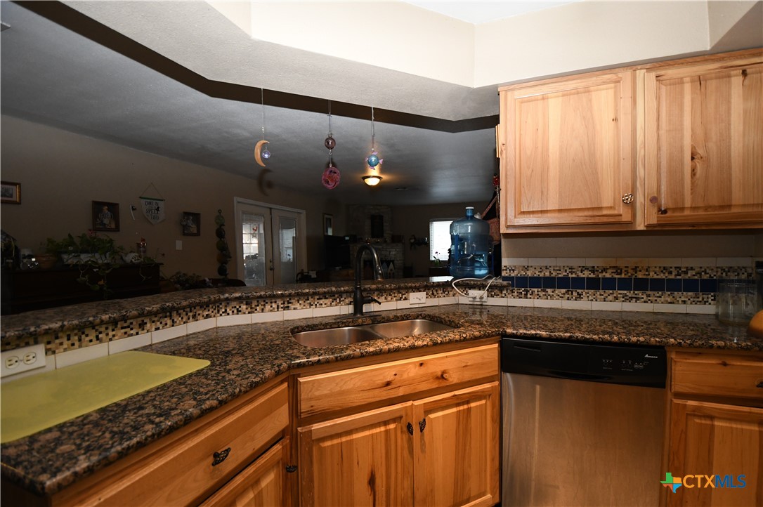 6019 Forest Ridge San Antonio, TX 78240 - Photo 7 of 25 a kitchen with stainless steel appliances granite countertop a sink stove and cabinets