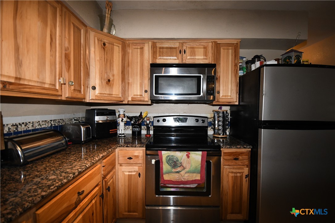 6019 Forest Ridge San Antonio, TX 78240 - Photo 8 of 25 a kitchen with a refrigerator stove and microwave
