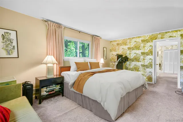 a living room with furniture a dining table and a floor to ceiling window