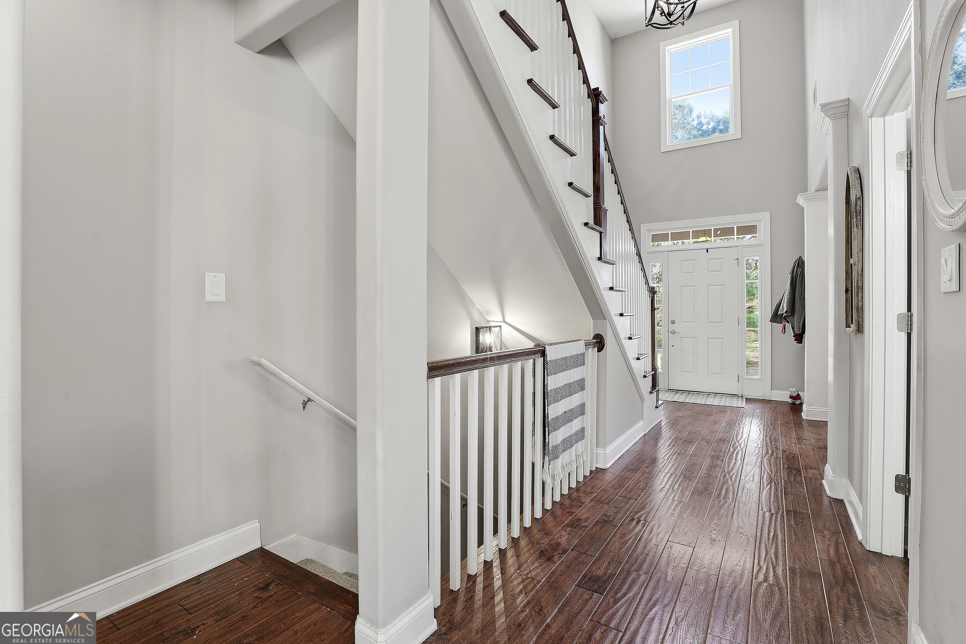 170 Emerson Ridge Trail Senoia, GA 30276 - Photo 15 of 24 a view of a hallway with wooden floor and stairs