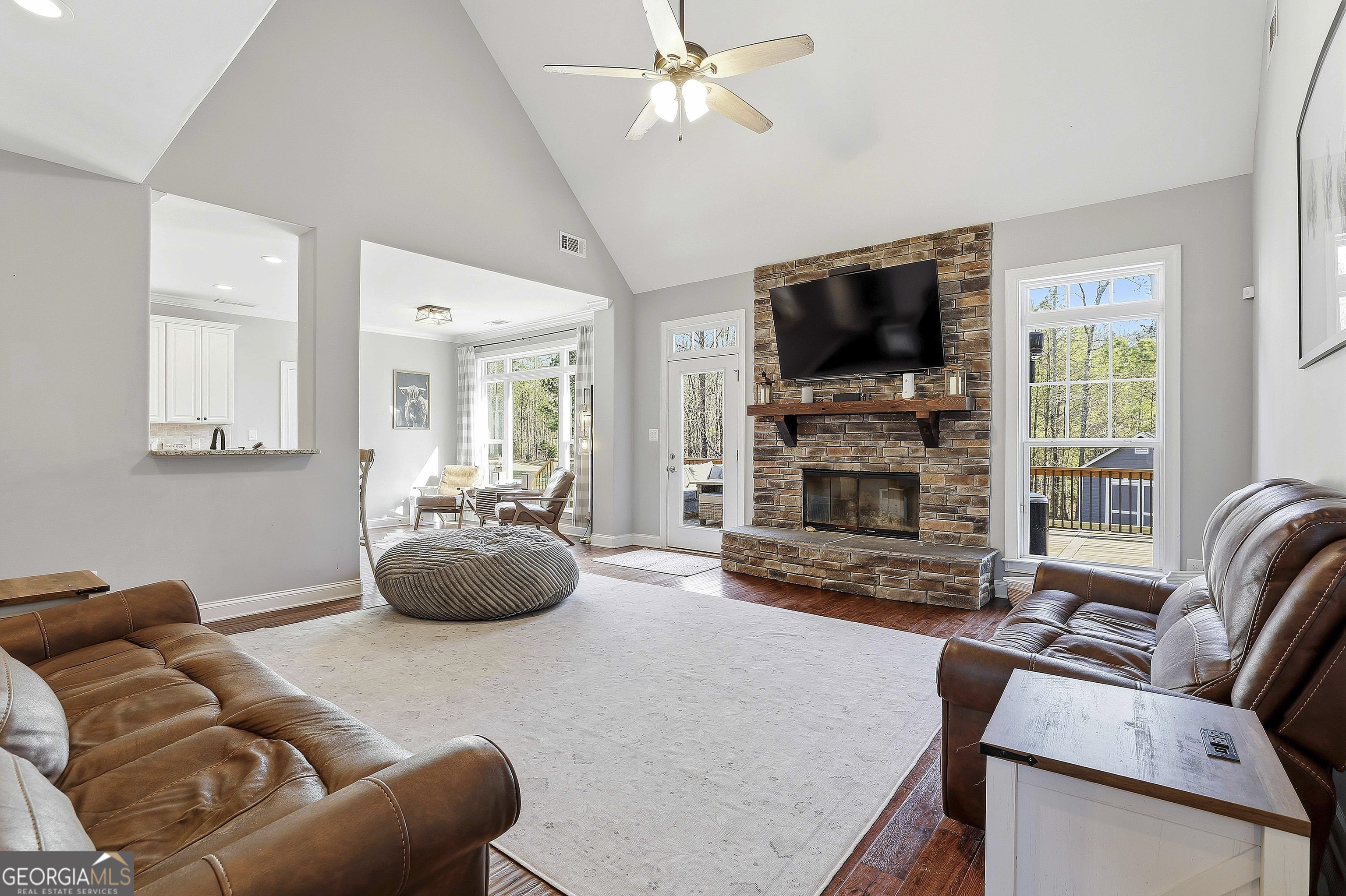 170 Emerson Ridge Trail Senoia, GA 30276 - Photo 16 of 24 a living room with furniture a flat screen tv and a fireplace