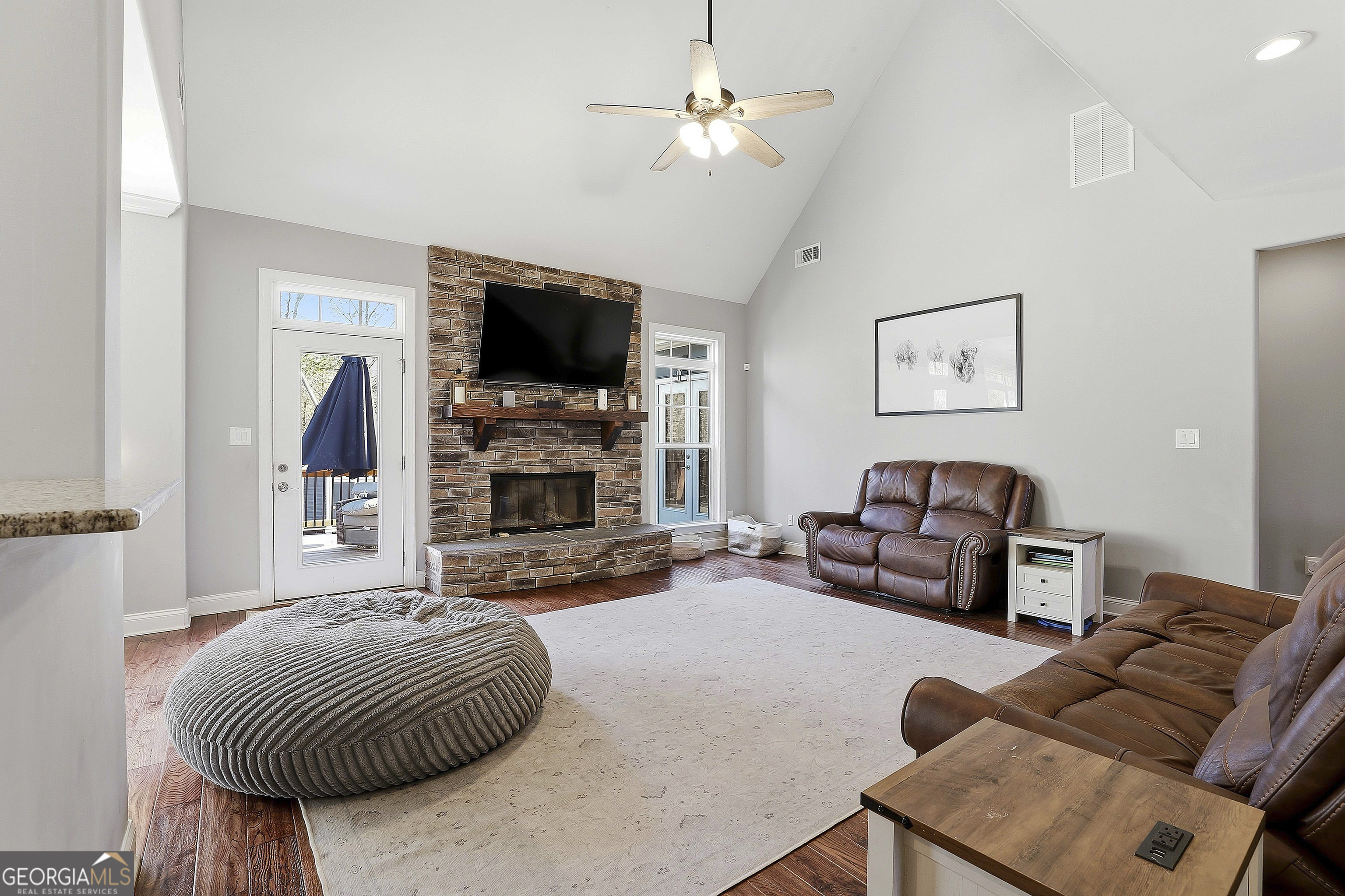 170 Emerson Ridge Trail Senoia, GA 30276 - Photo 17 of 24 a living room with furniture a flat screen tv and a fireplace