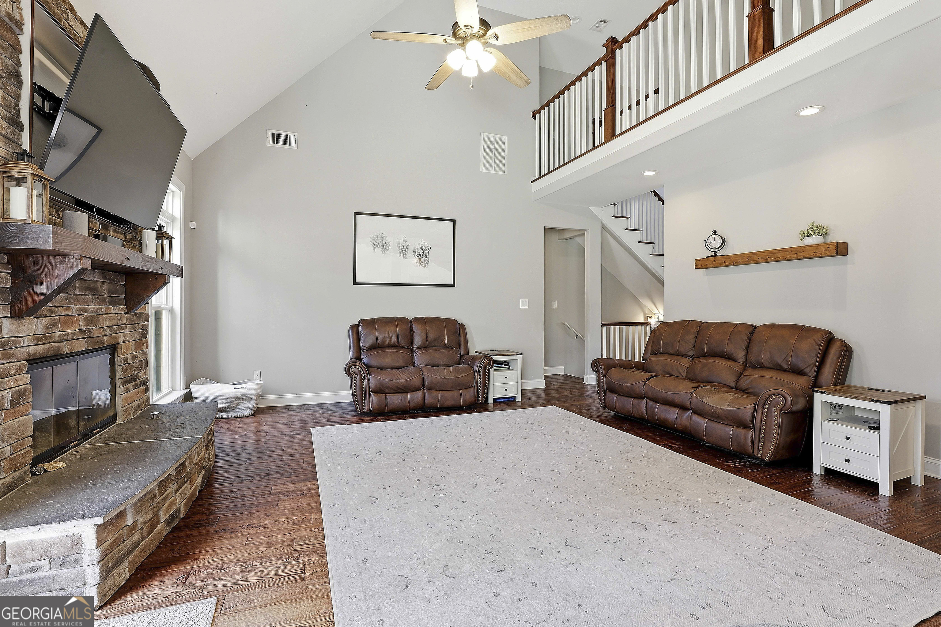 170 Emerson Ridge Trail Senoia, GA 30276 - Photo 19 of 24 a living room with furniture a fireplace and a flat screen tv