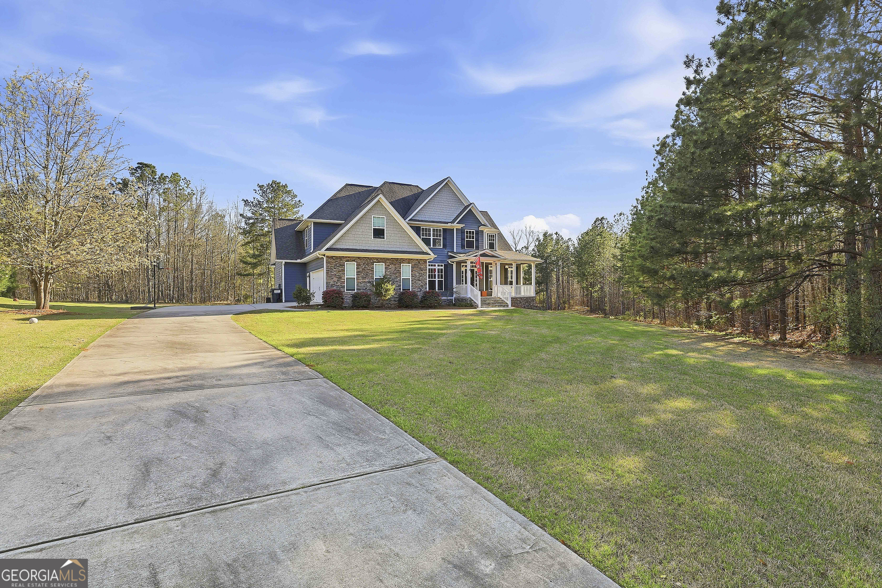 170 Emerson Ridge Trail Senoia, GA 30276 - Photo 2 of 24 a view of a house with a big yard and large trees