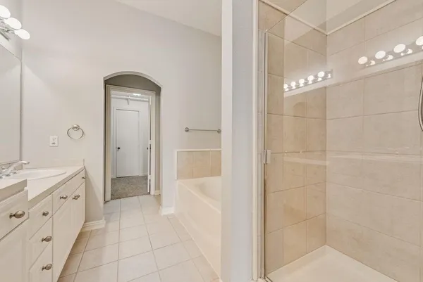 a bathroom with a double vanity sink a toilet and shower