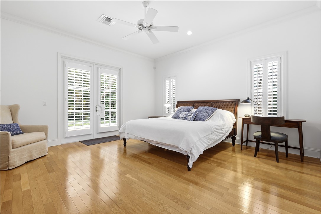 2116 Cavalla Road Vero Beach, FL 32963 - Photo 7 of 23 a bedroom with a bed a couch and a dresser with wooden floor