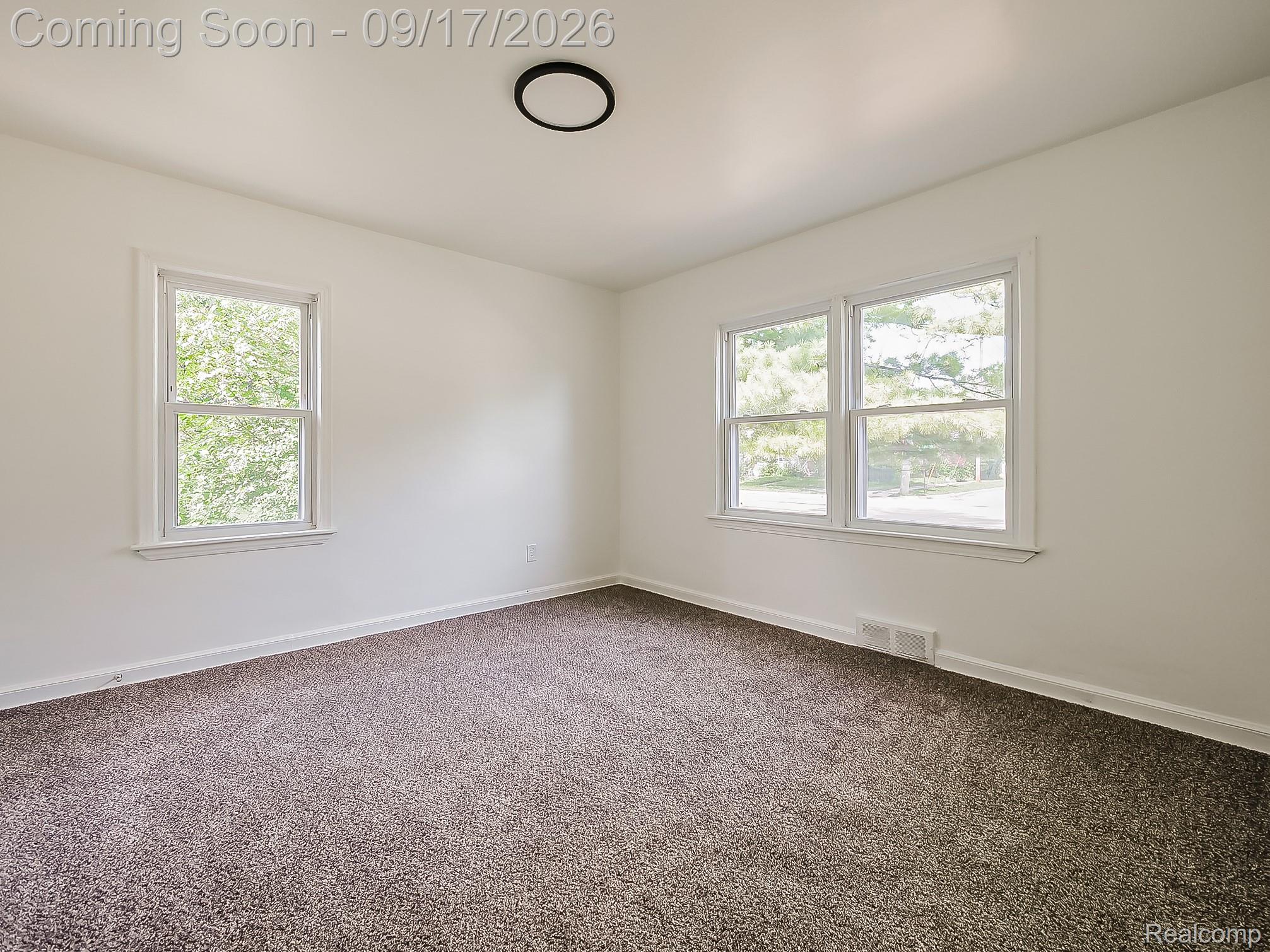 14102 Toepfer Road Warren, MI 48089 - Photo 10 of 39 Neutral wall paint, plush carpeting, a single window, and a double window with white trim, complemented by a flush-mount ceiling light