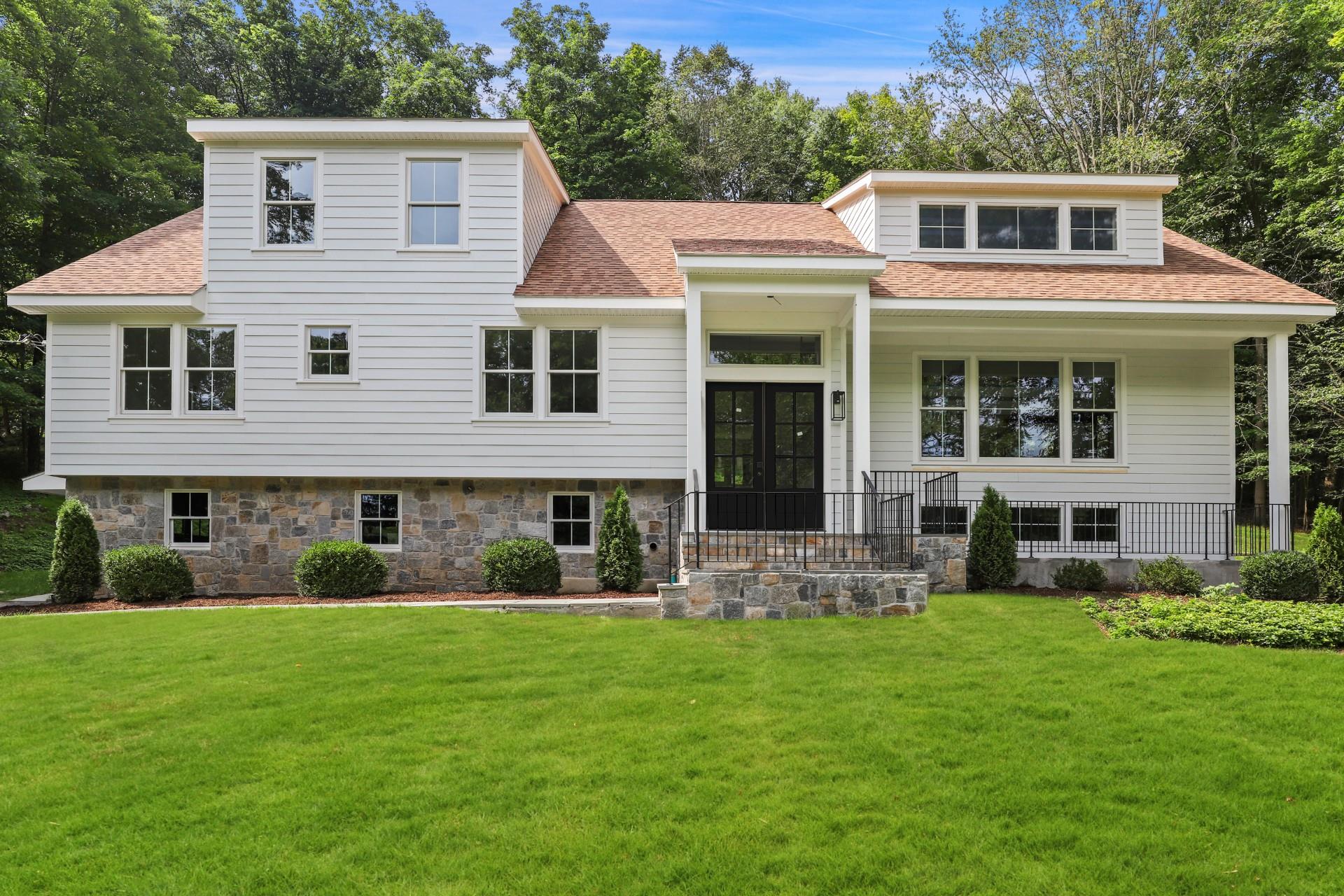 a front view of house with yard and green space