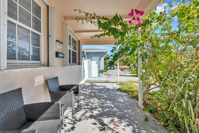 a view of a patio with couches and potted plants