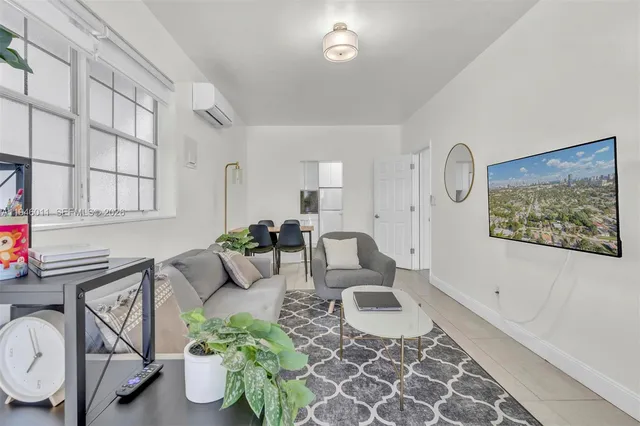 a living room with furniture a rug and a painting on the wall