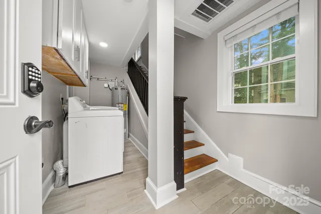a en suite bathroom with a granite countertop sink and a mirror