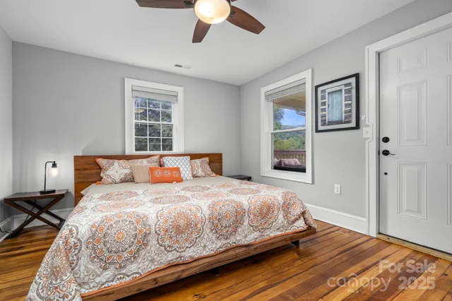 an empty room with a window and wooden floor
