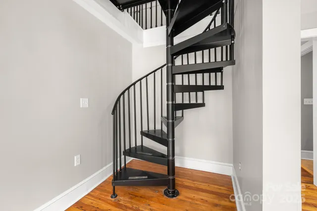 a bedroom with furniture and a wooden floor