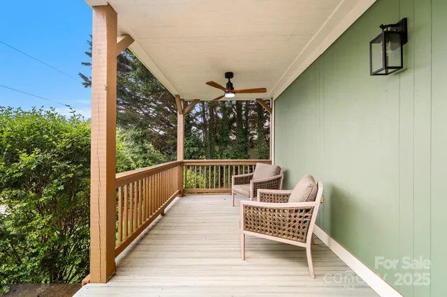 a roof deck with chair and wooden floor