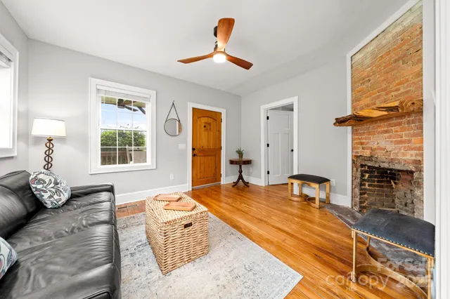 a living room with furniture gym equipment and a fireplace