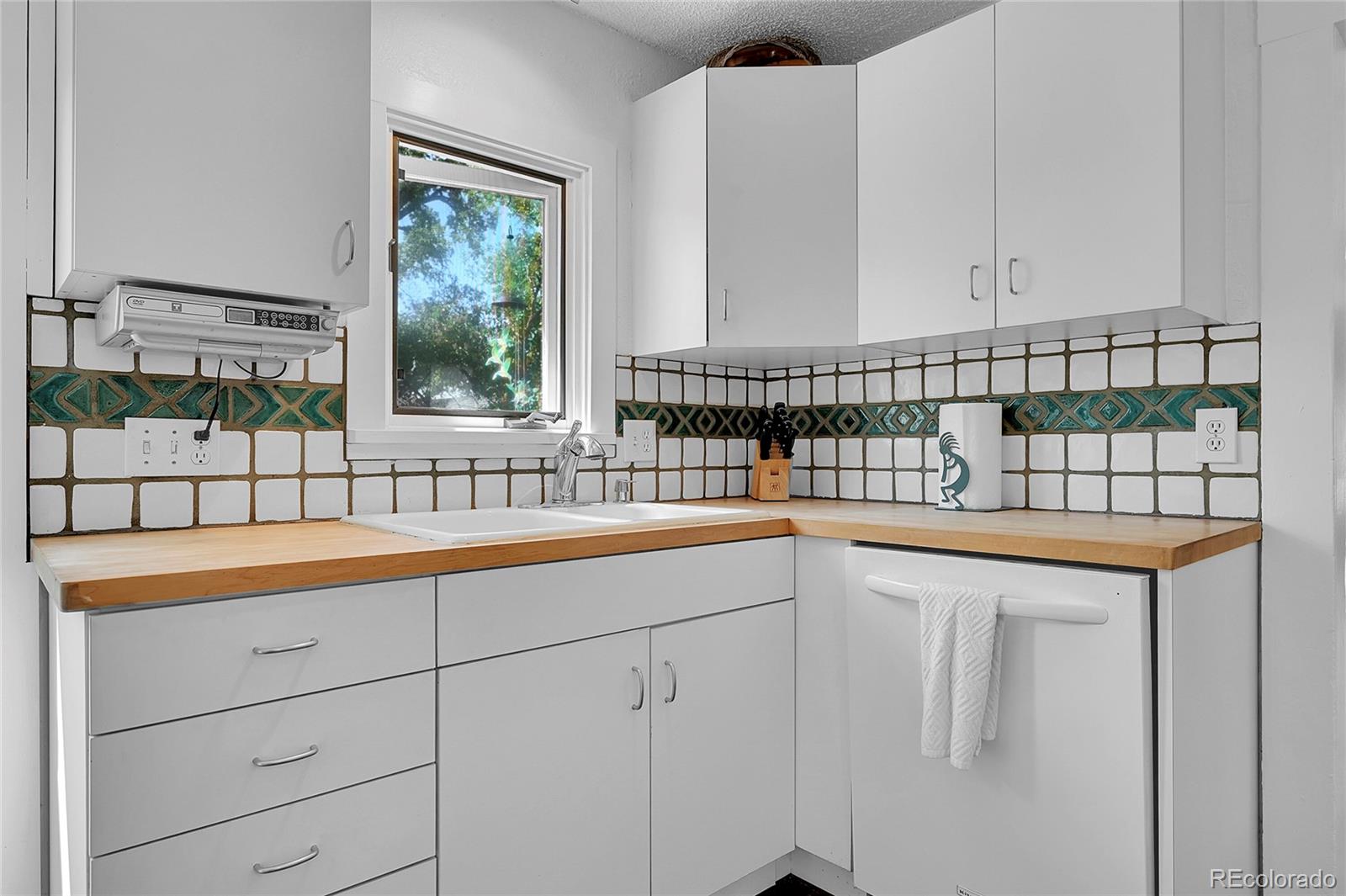141 3rd Avenue Niwot, CO 80544 - Photo 17 of 49 a utility room with stainless steel appliances a sink and cabinets