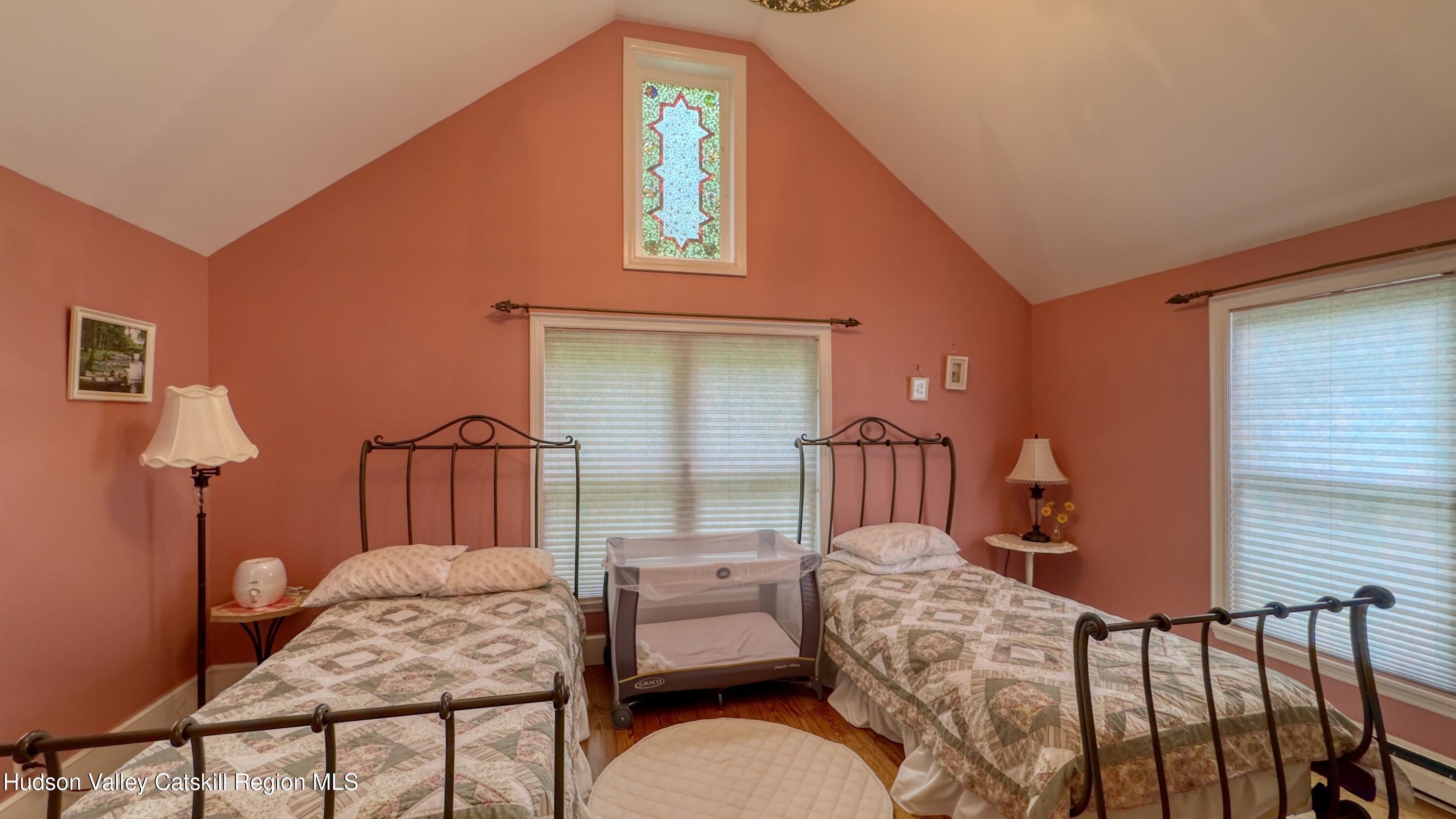 66 Castle Point Road Athens, NY 12015 - Photo 13 of 44 a bedroom with a bed and dresser with wooden floor