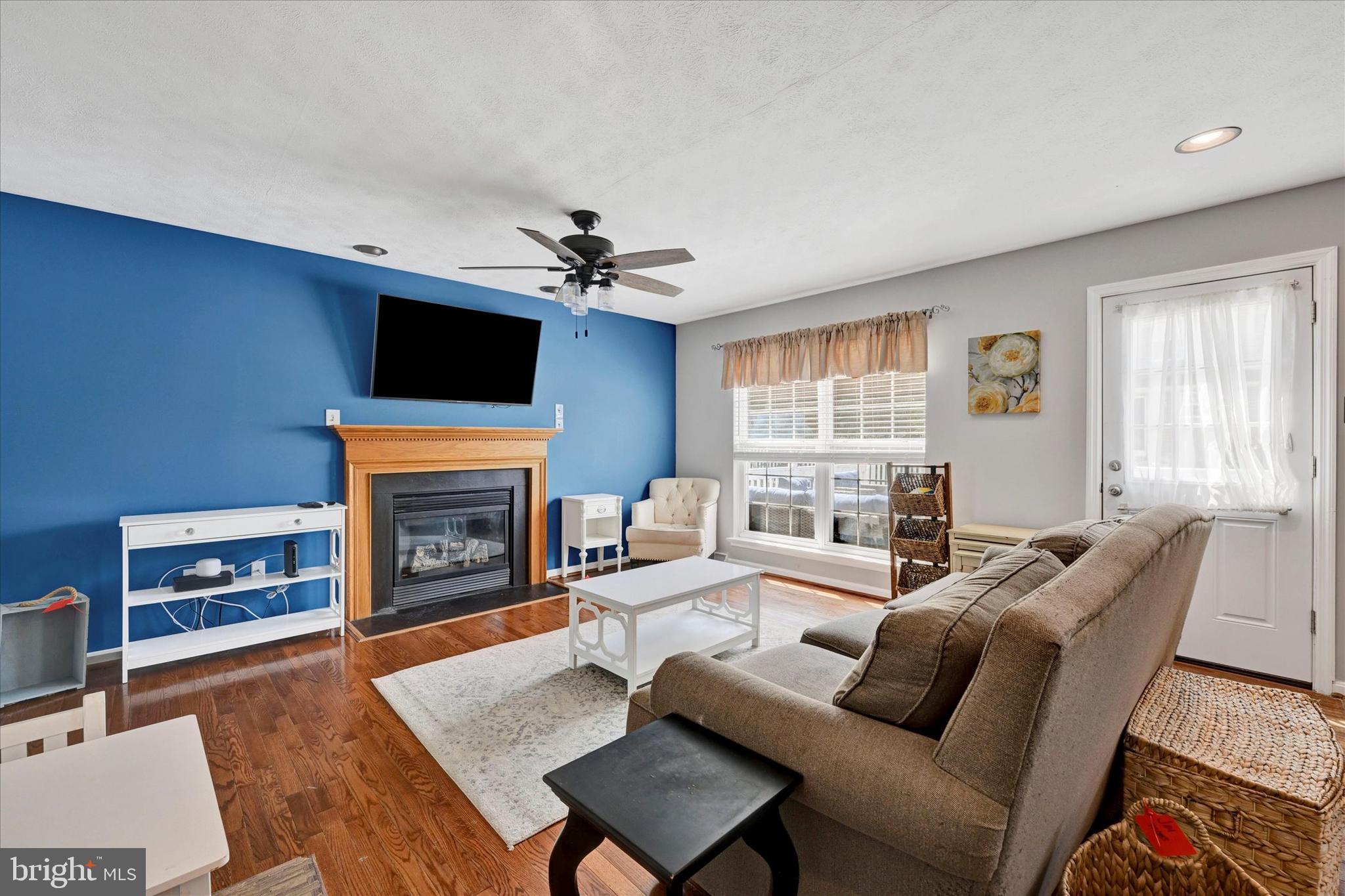 4195 Fallow Drive Hampstead, MD 21074 - Photo 11 of 40 a living room with furniture a flat screen tv and a fireplace