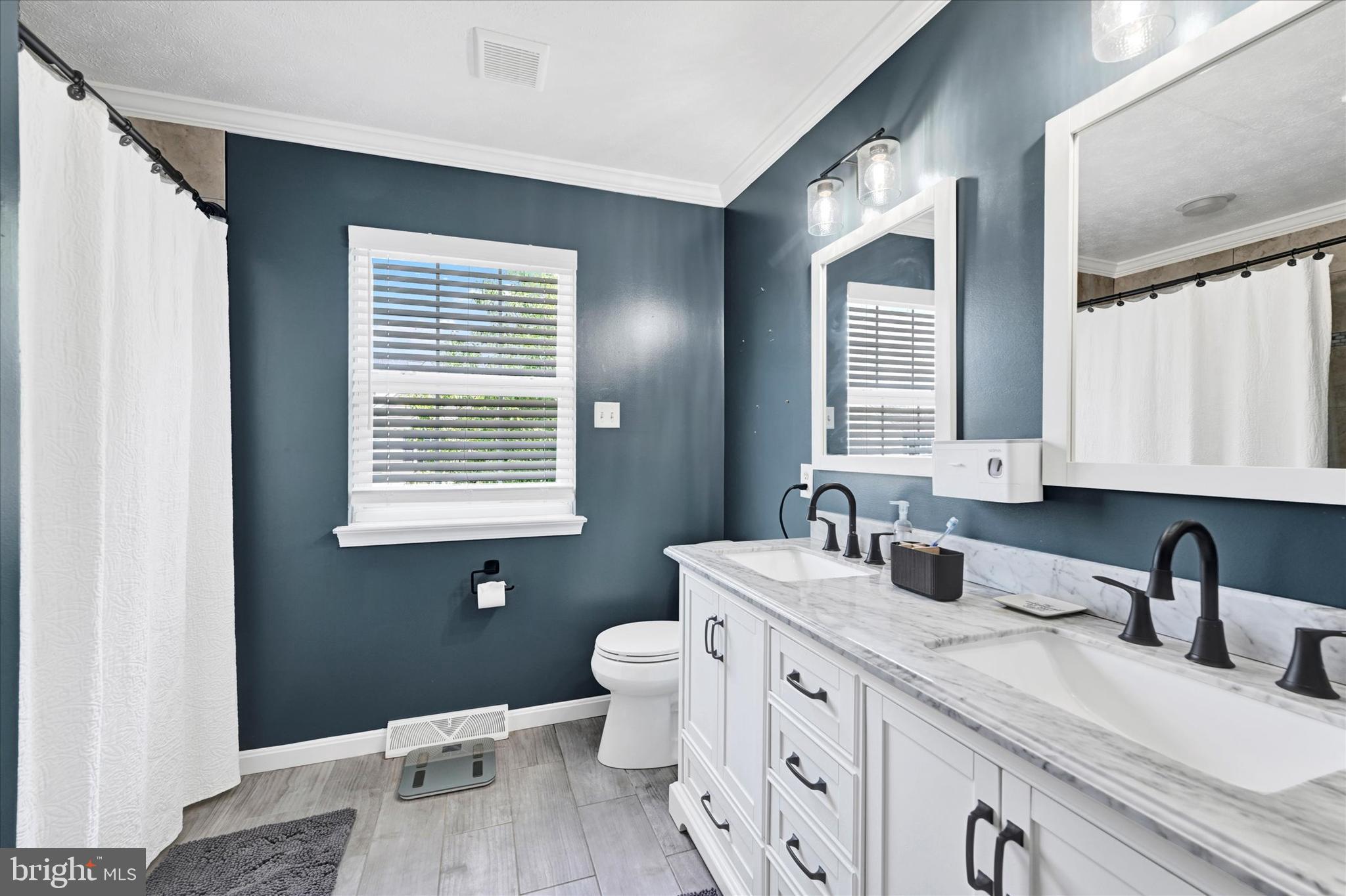 4195 Fallow Drive Hampstead, MD 21074 - Photo 20 of 40 a bathroom with a granite countertop sink toilet a large mirror and a window