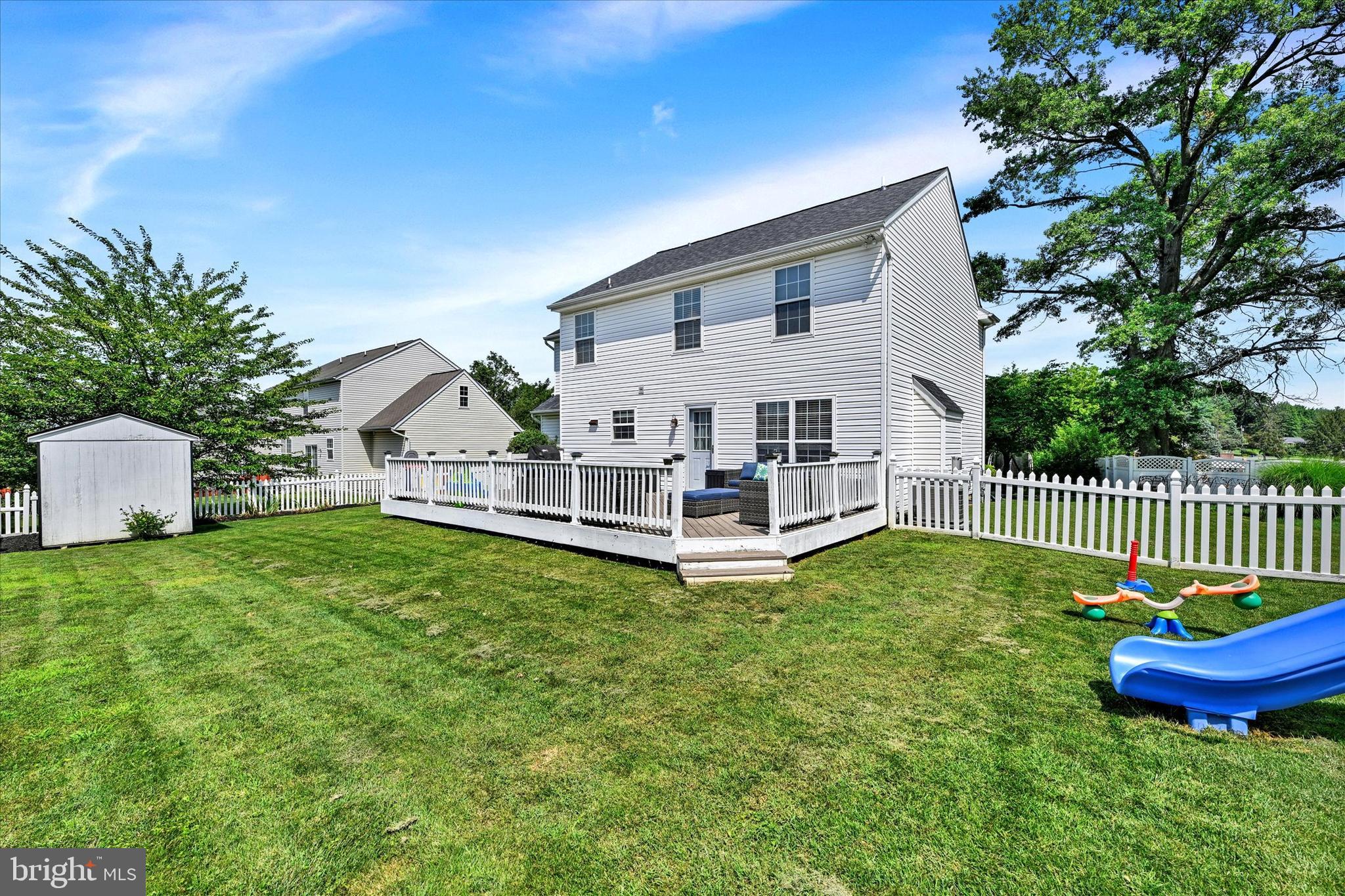 4195 Fallow Drive Hampstead, MD 21074 - Photo 29 of 40 a white house with a small yard and large trees