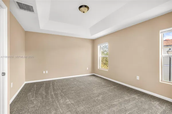 a view of an empty room with a window