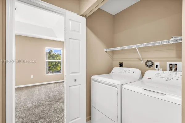 a view of storage and utility room with washer and dryer
