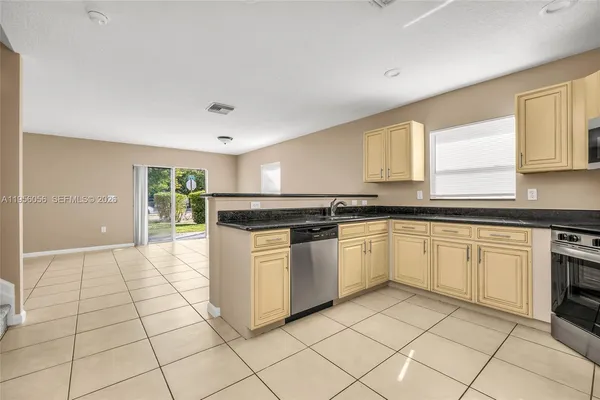 a kitchen with stainless steel appliances granite countertop a stove and a sink