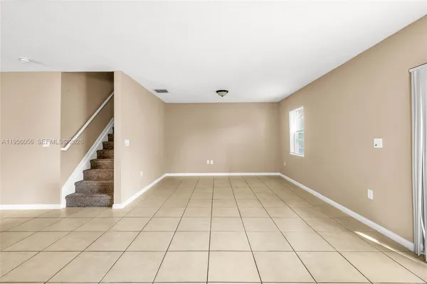 a view of an empty room with a window