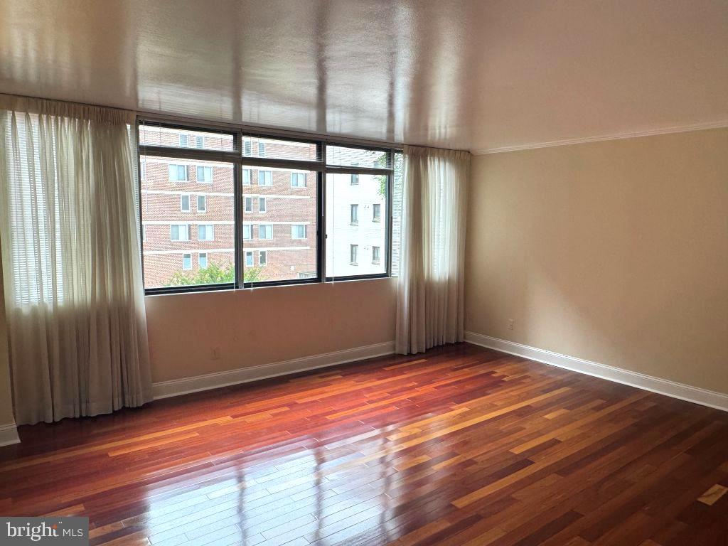 1245 13th Street Northwest, Unit 313 Washington, DC 20005 - Photo 15 of 43 an empty room with wooden floor and windows