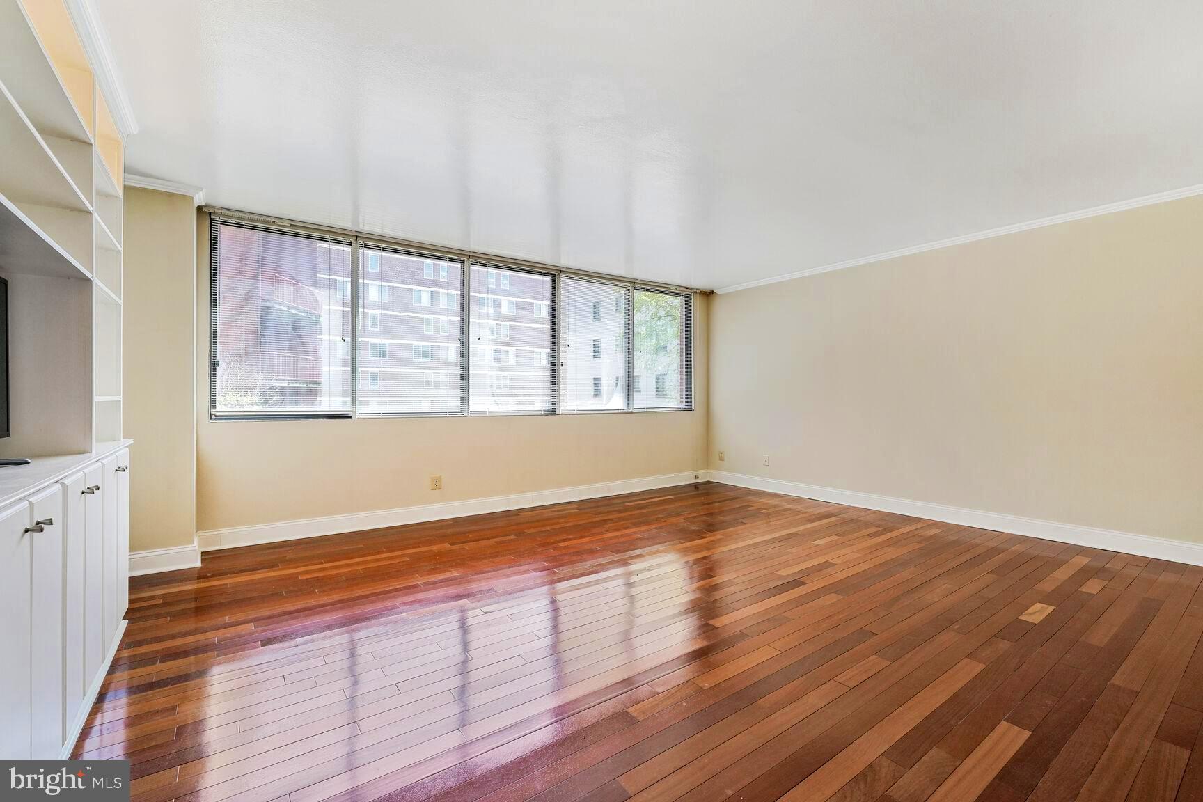 1245 13th Street Northwest, Unit 313 Washington, DC 20005 - Photo 16 of 43 a view of an empty room with wooden floor and a window