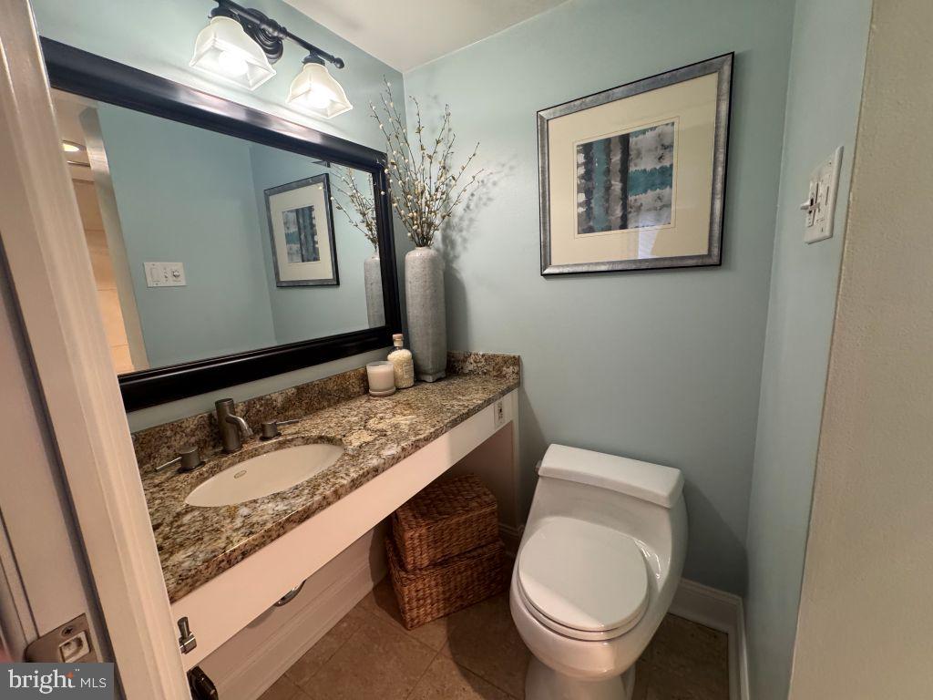 1245 13th Street Northwest, Unit 313 Washington, DC 20005 - Photo 19 of 43 a bathroom with a toilet sink and mirror