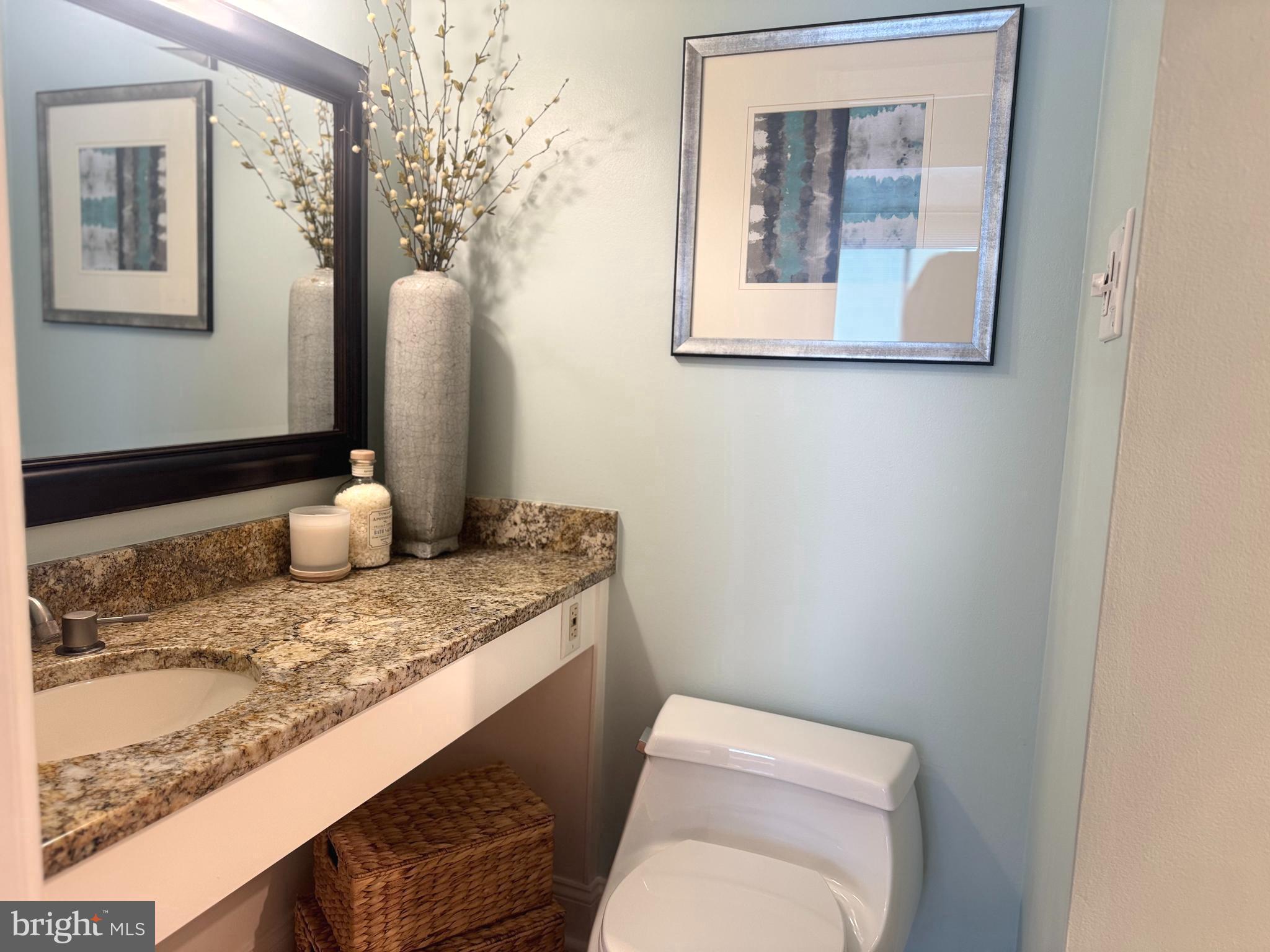1245 13th Street Northwest, Unit 313 Washington, DC 20005 - Photo 20 of 43 a bathroom with a toilet sink and mirror