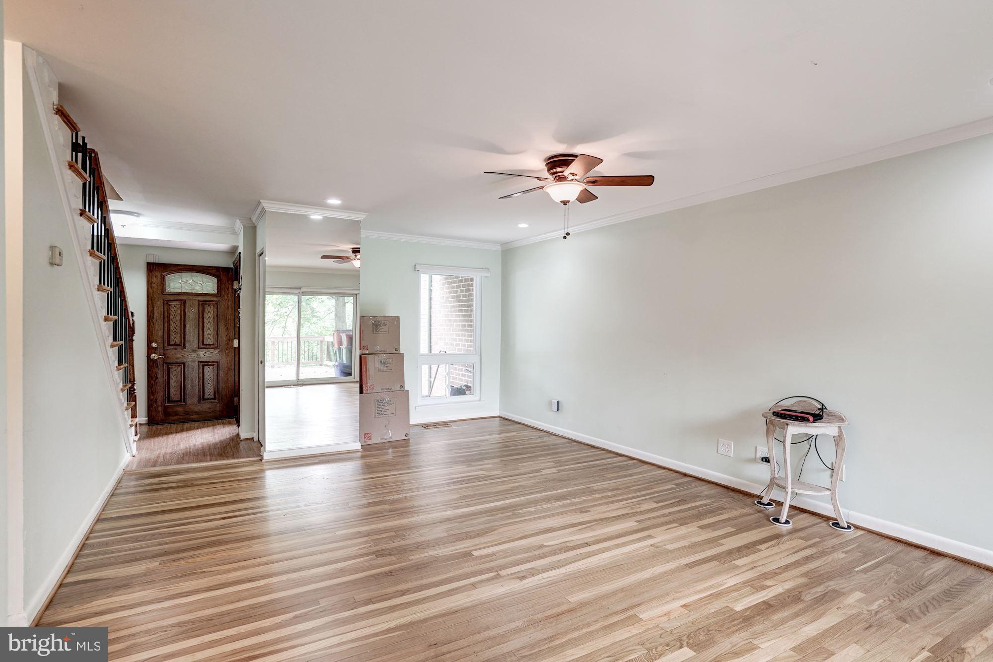 11089 Saffold Way Reston, VA 20190 - Photo 2 of 30 a view of an empty room with a window and wooden floor