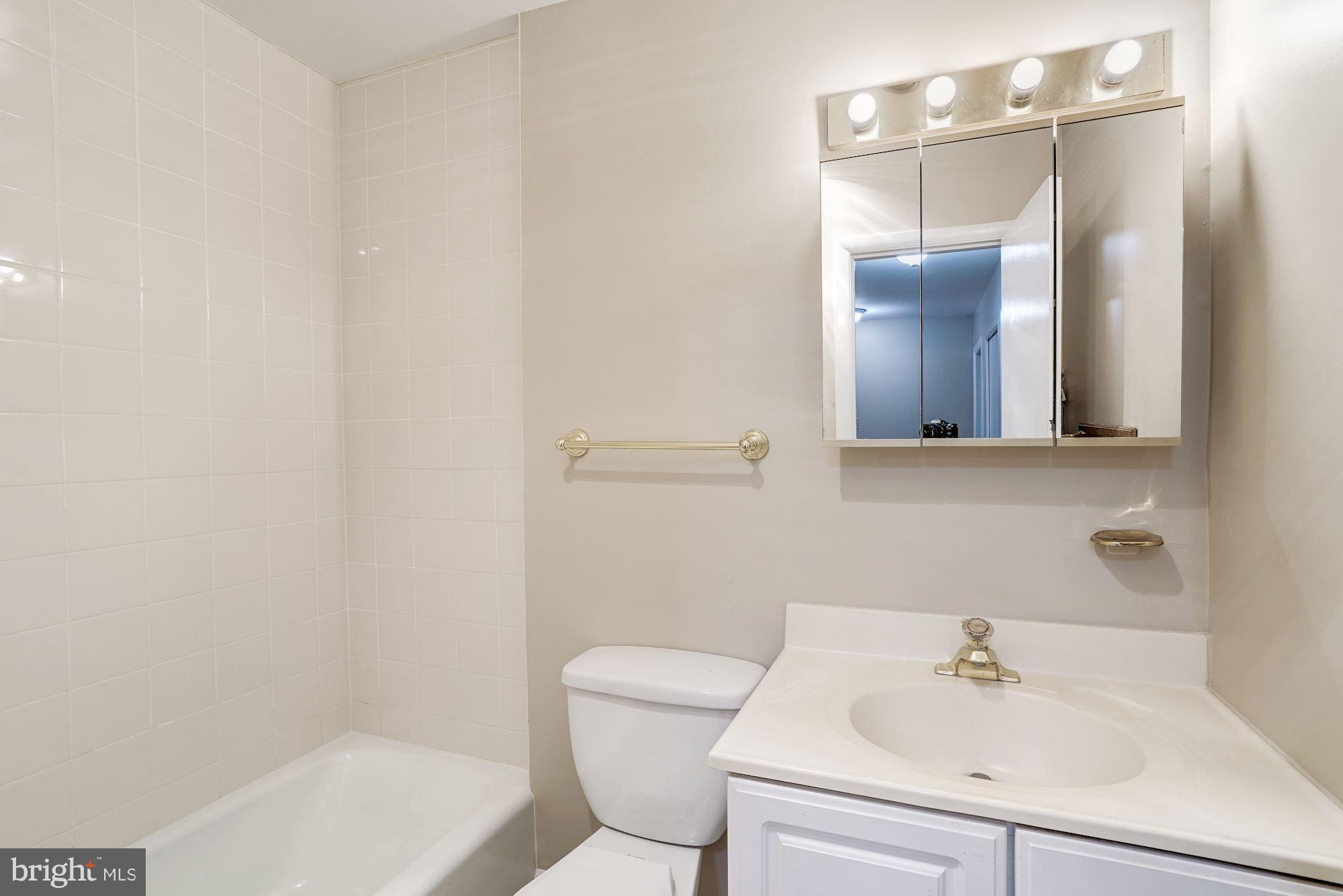 11089 Saffold Way Reston, VA 20190 - Photo 13 of 30 a bathroom with a sink a toilet and shower
