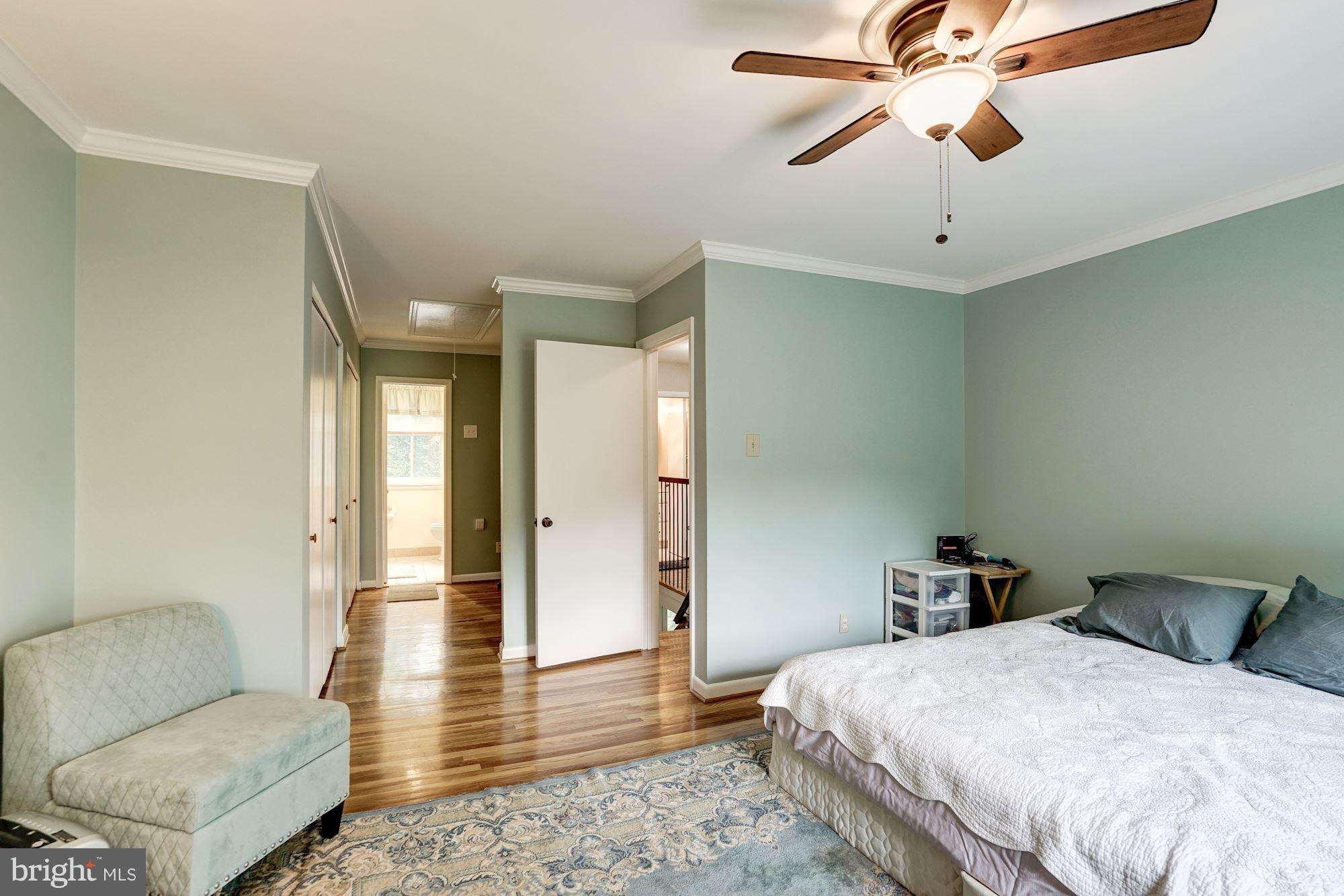 11089 Saffold Way Reston, VA 20190 - Photo 15 of 30 a spacious bedroom with a bed and furniture