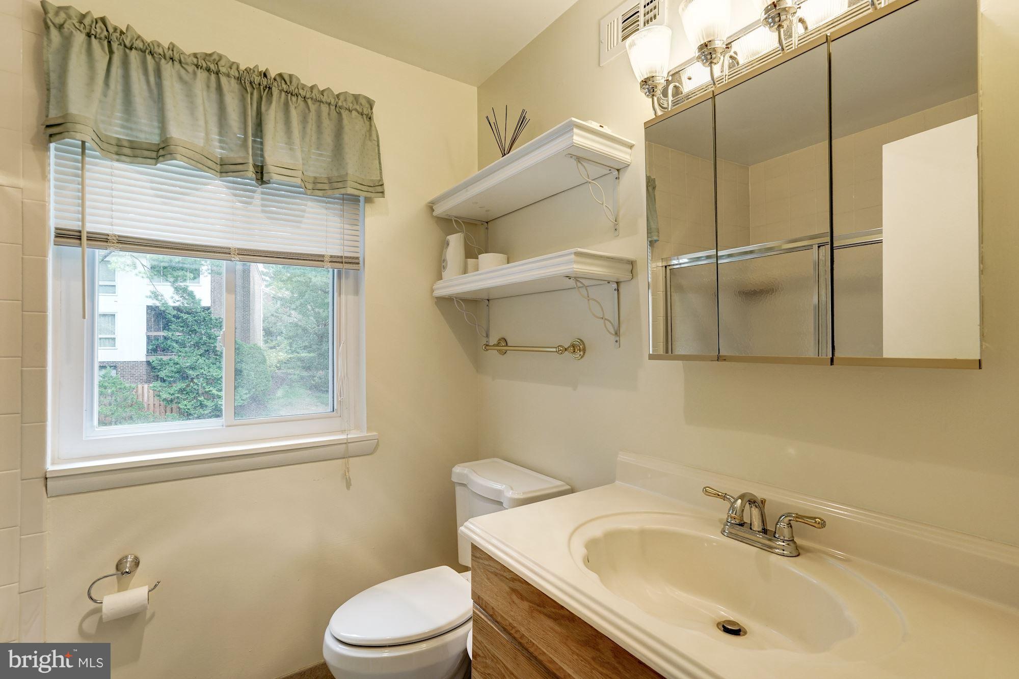 11089 Saffold Way Reston, VA 20190 - Photo 17 of 30 a bathroom with a sink toilet and shower