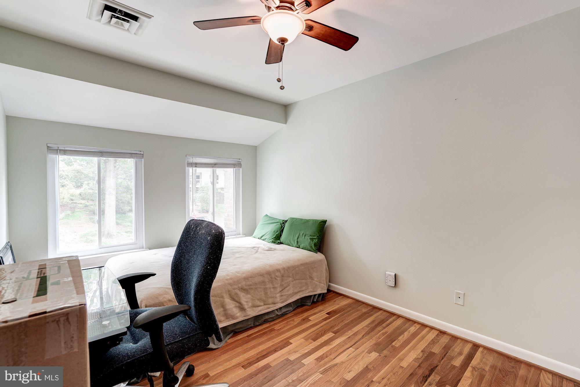 11089 Saffold Way Reston, VA 20190 - Photo 20 of 30 a bedroom with a bed and a chair