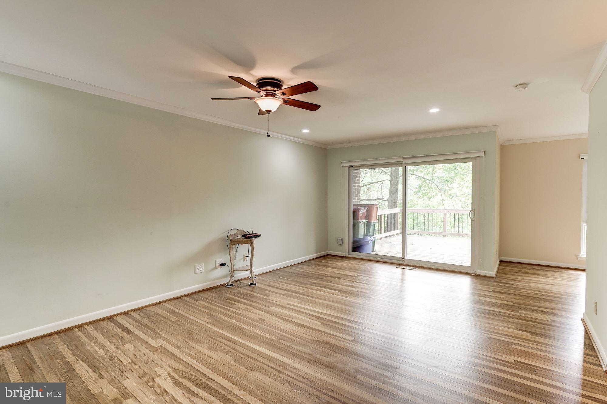 11089 Saffold Way Reston, VA 20190 - Photo 4 of 30 a view of an empty room with a window and wooden floor