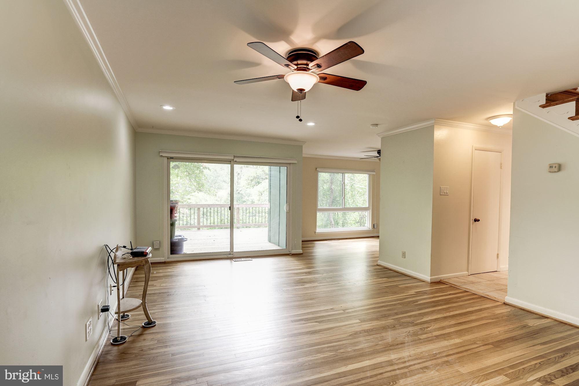 11089 Saffold Way Reston, VA 20190 - Photo 5 of 30 a view of an empty room with a window and wooden floor