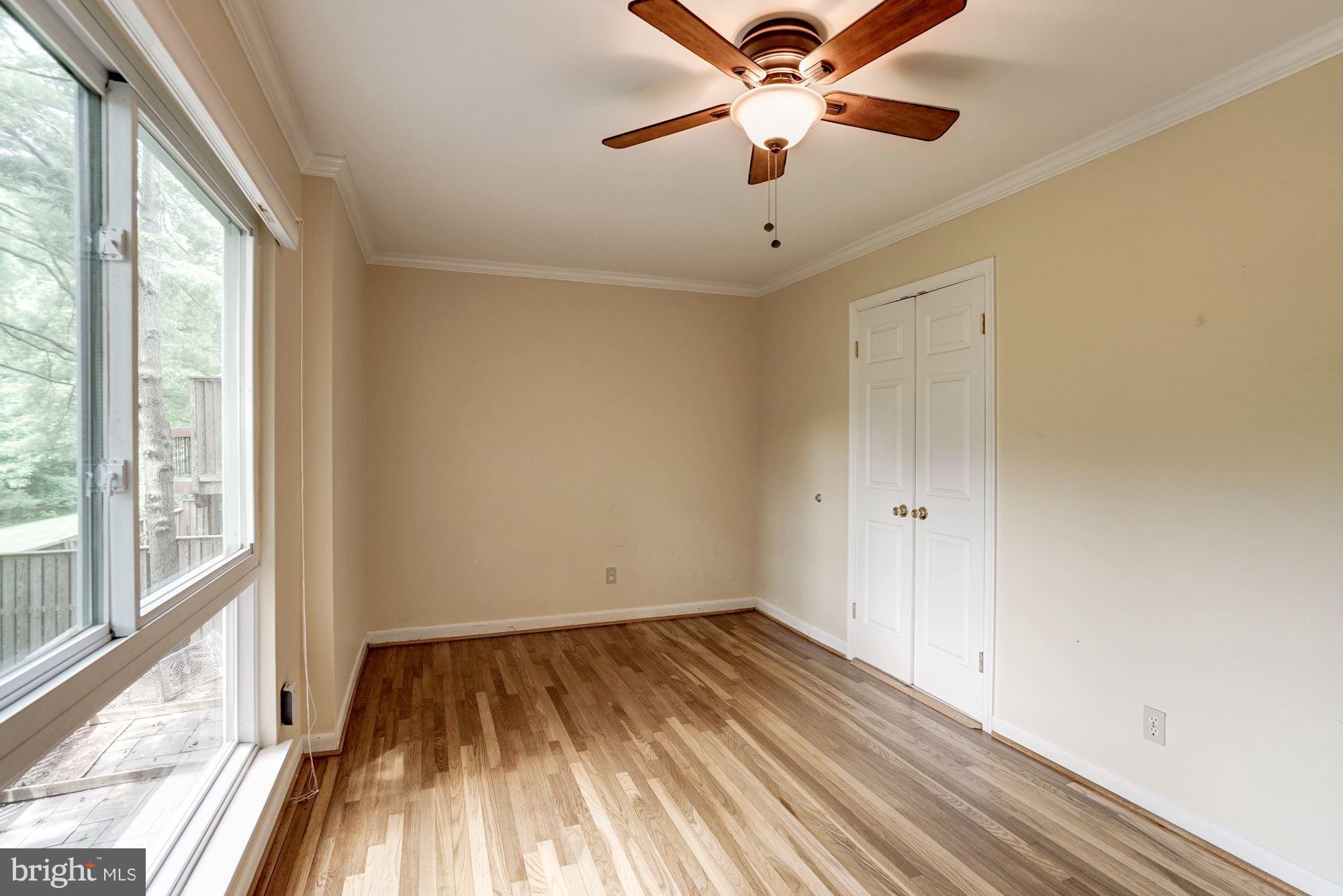 11089 Saffold Way Reston, VA 20190 - Photo 6 of 30 a view of a room with wooden floor and a ceiling fan