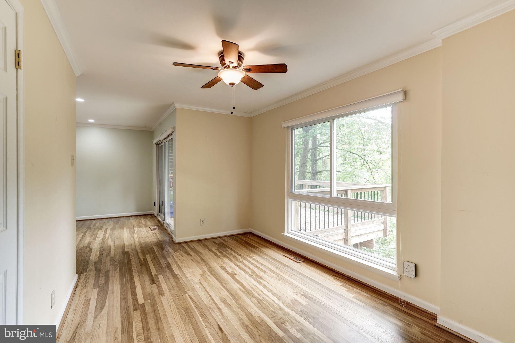 11089 Saffold Way Reston, VA 20190 - Photo 8 of 30 a view of an empty room with wooden floor and a window
