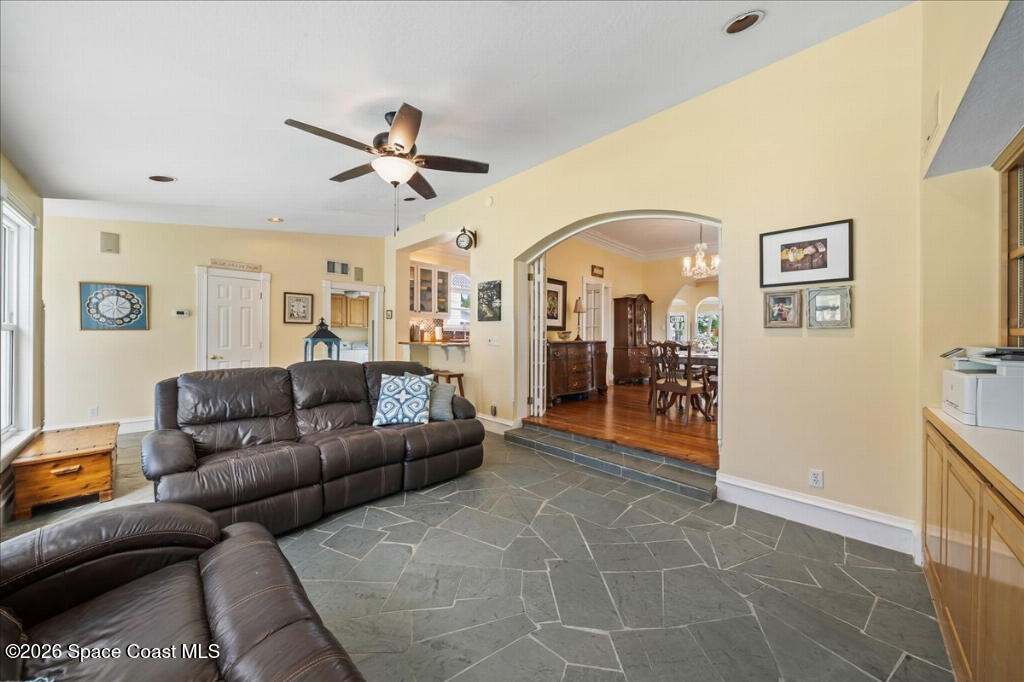 1110 Riverside Drive Titusville, FL 32780 - Photo 12 of 50 a living room with furniture and a chandelier