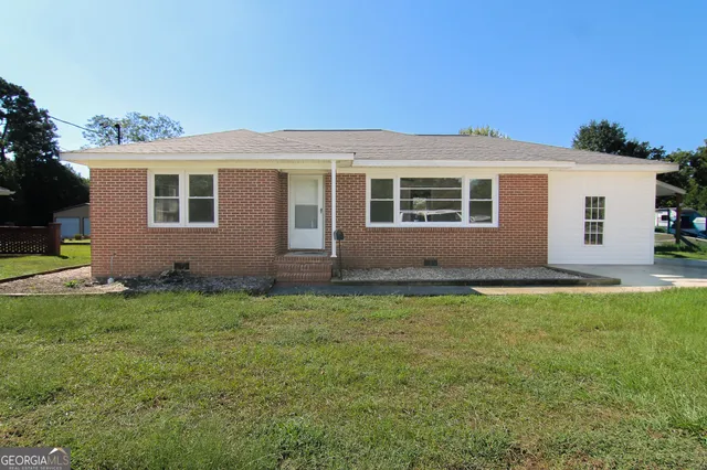 a backyard of a house with yard and barbeque oven