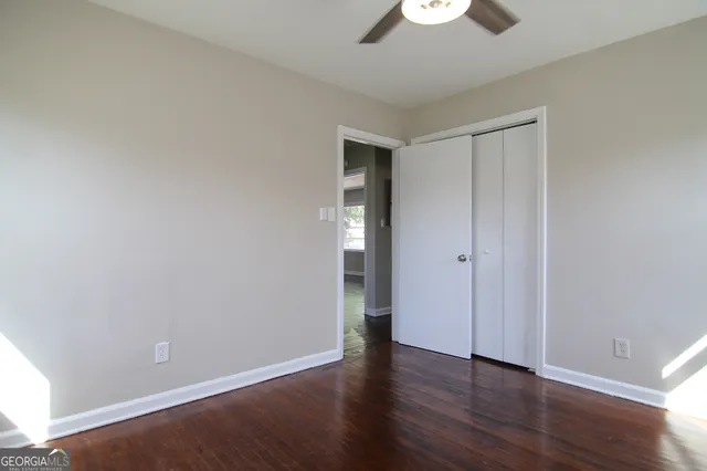 a view of an empty room with wooden floor