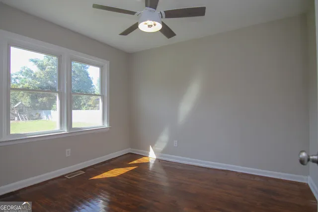 wooden floor in an empty room with a window