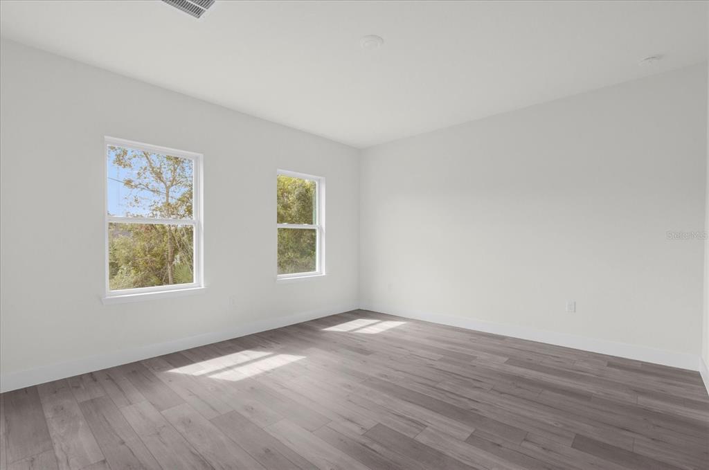 2396 Southwest 147th Lane Road Ocala, FL 34473 - Photo 12 of 32 a view of an empty room with wooden floor and a window