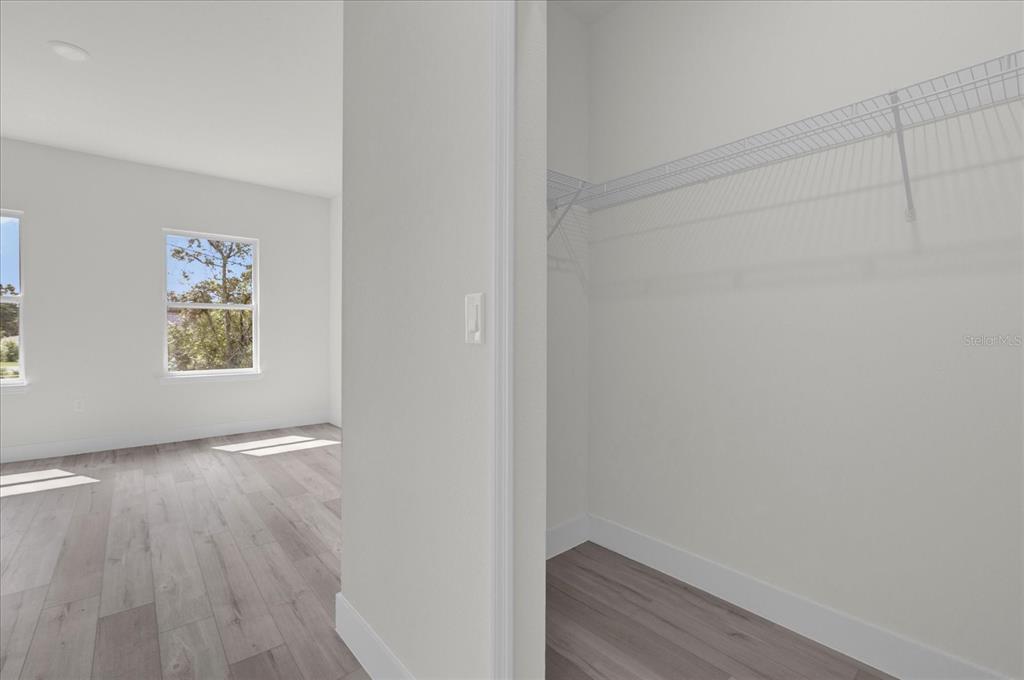 2396 Southwest 147th Lane Road Ocala, FL 34473 - Photo 14 of 32 a view of an empty room with wooden floor and a window