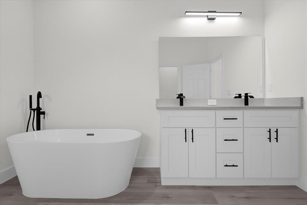 2396 Southwest 147th Lane Road Ocala, FL 34473 - Photo 15 of 32 a white bath tub sitting in a bathroom