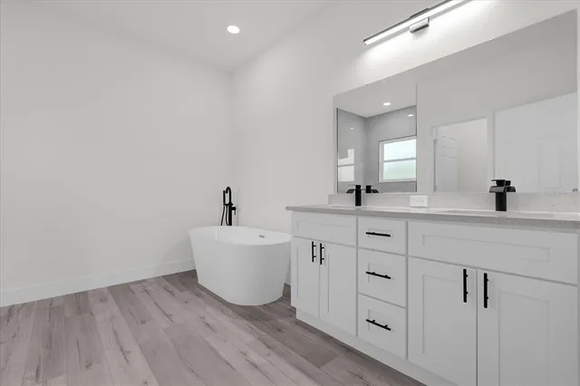 a bathroom with a double vanity sink and mirror