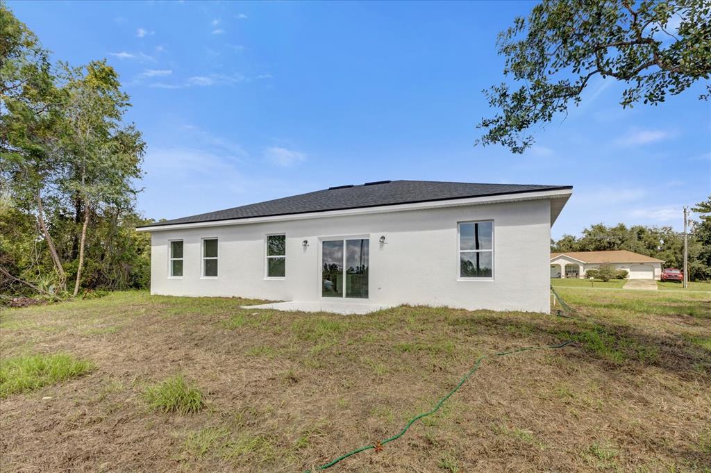 2396 Southwest 147th Lane Road Ocala, FL 34473 - Photo 27 of 32 a house with trees in the background